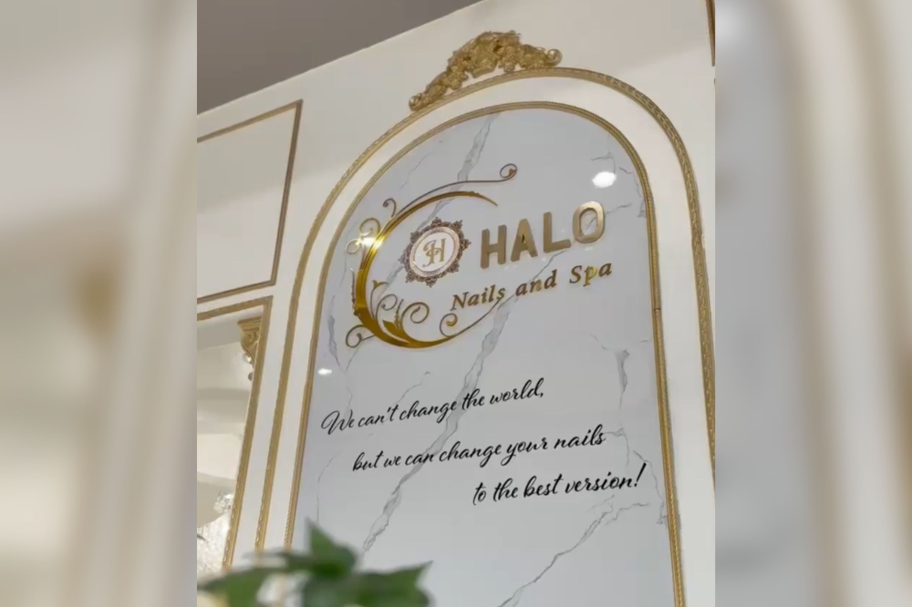 Halo Nails and Spa logo wall with gold lettering on marble